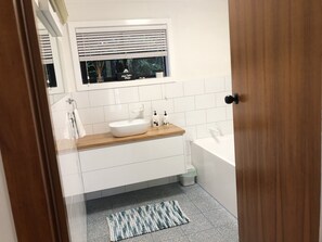 Bathtub, hair dryer, towels, soap