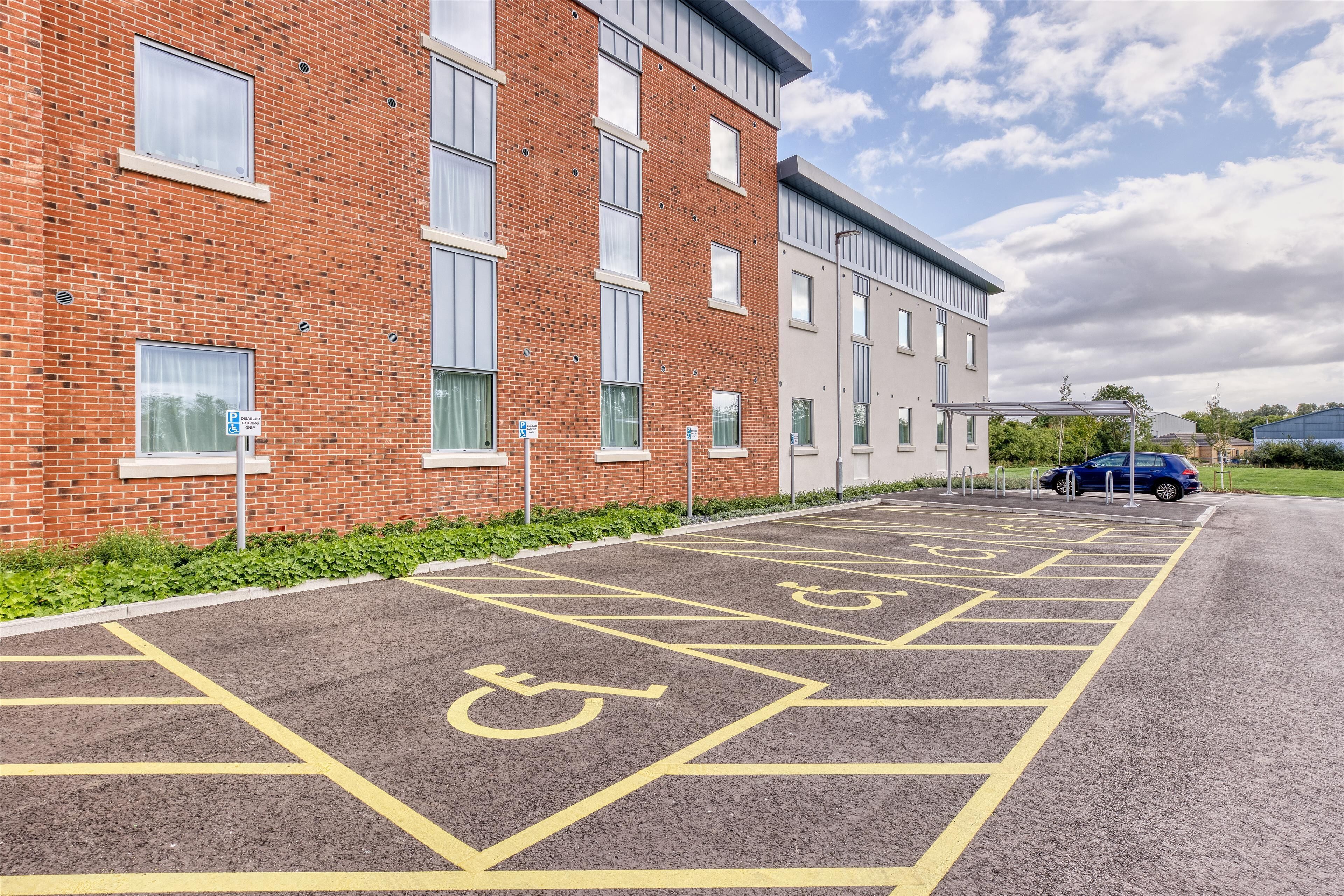 A parking area with disabled parking spaces marked on the pavement.