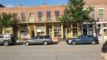 A street view with a two-story building featuring a ground-floor bookstore and a second-floor restaurant.