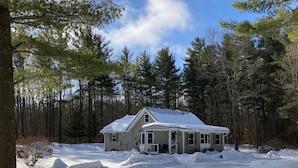 A two-story house with a snow-covered roof, surrounded by a forest. - The Quiet Spot Cabin (Naples)
