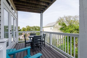 Enjoy a tranquil outdoor space with a deck, table, and comfortable seating for four.