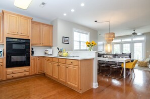 Enjoy cooking in the well-lit kitchen with a central island, sink, and ample counter space.