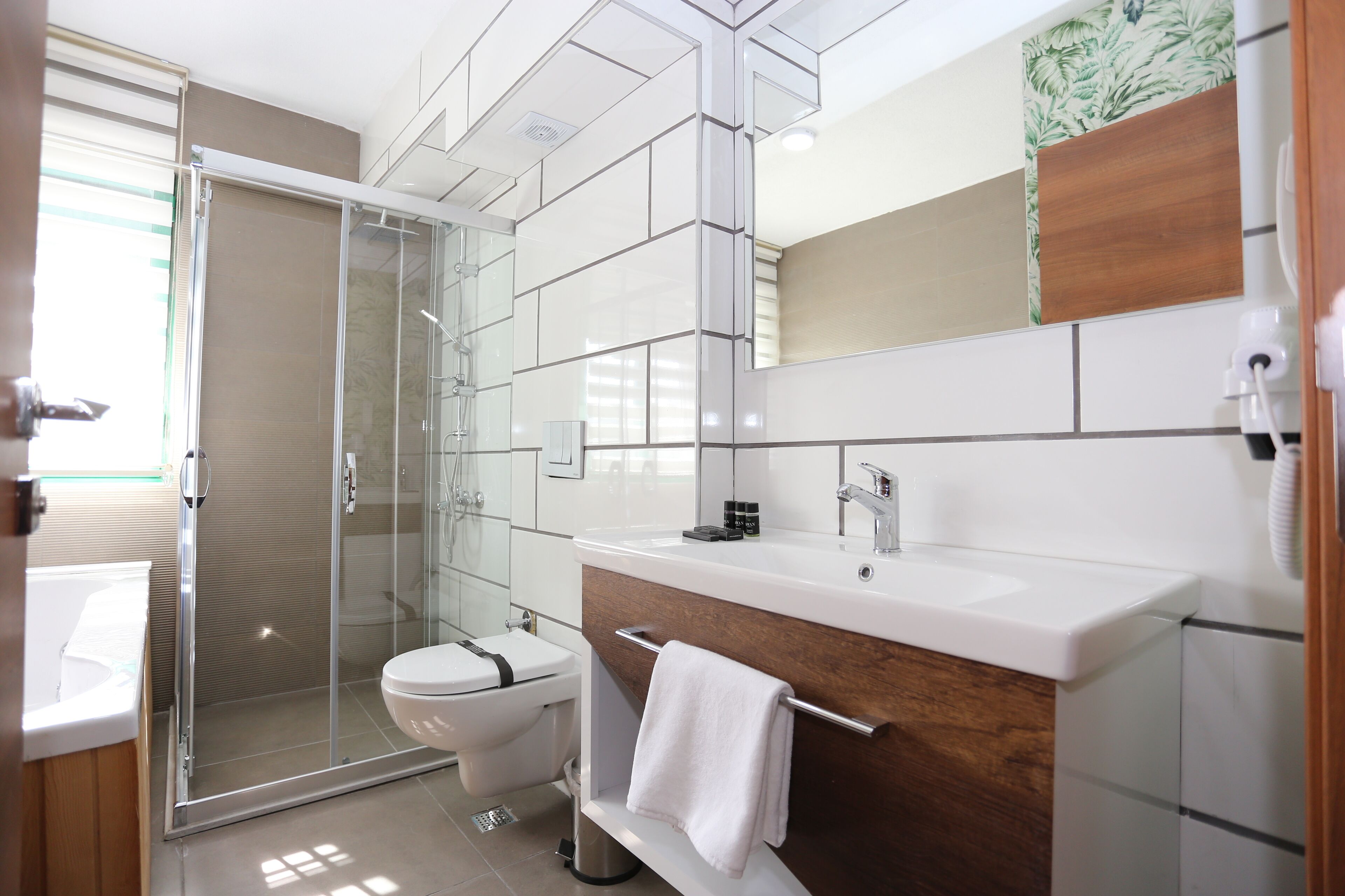junior double room | bathroom | rainfall showerhead, free toiletries, hair dryer, bathrobes