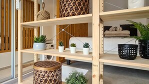 A modern interior with wooden shelving, potted plants, and a visible laundry area. - Phaedrus Living: Seaside Luxury Flat Athina 123 (Paphos)