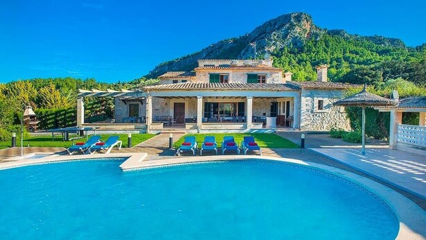 A pool with lounge chairs, a stone building with a tiled roof, and a mountainous backdrop. - Finca Rafalet, Charming villa close to Pollensa (Pollença)