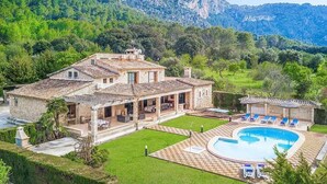 A villa with a swimming pool, outdoor seating, and a mountainous backdrop. - Finca Rafalet, Charming villa close to Pollensa (Pollença)