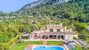 A villa with a swimming pool, surrounded by lush greenery and mountains. - Finca Rafalet, Charming villa close to Pollensa (Pollença)