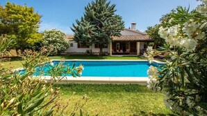 A house with a swimming pool surrounded by greenery and a large tree. - Villa Sol Roma, 3 bedrooms villa  with pool near Pollensa (Pollença)