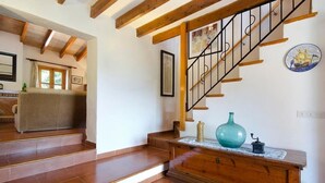 A staircase with wooden beams and a black railing leading to a landing. - Villa Varella, Pretty villa close to Pollensa (Pollença)
