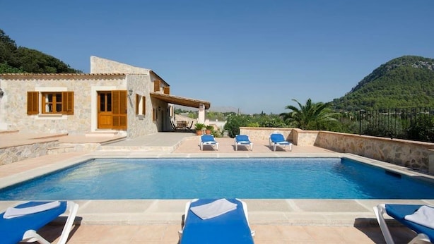 A pool area with lounge chairs and a stone building. - Villa Varella, Pretty villa close to Pollensa (Pollença)