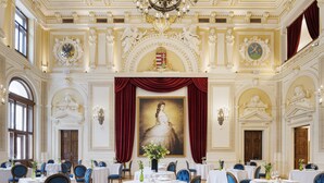 A grand dining hall with ornate ceiling decorations, a large portrait, and multiple tables set for dining. - Aurea Ana Palace by Eurostars Hotel Company (Budapest)