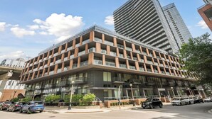 A modern multi-story building with a flat roof and large windows, likely a hotel or office building.