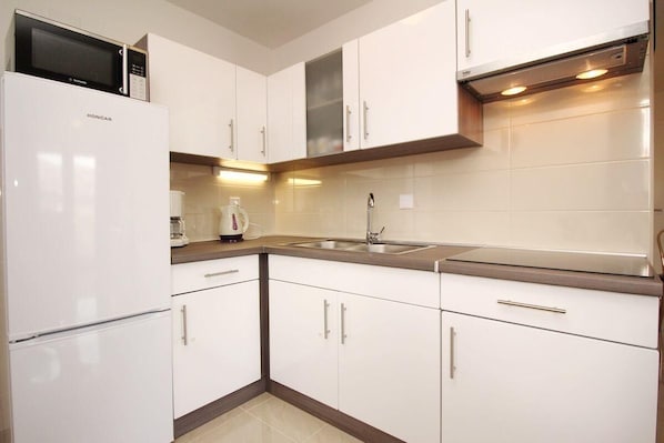 Køleskab, mikrobølgeovn, spisebord