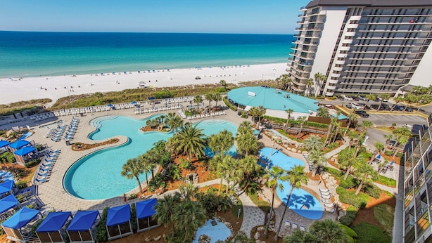 A resort with multiple swimming pools, a beach, and a high-rise building. - Hello Sunshine Edgewater, Tower 1, #905-Beachfront! 2Bd-2Ba-Sleeps 6-Fun In The Sun! (Panama City Beach)