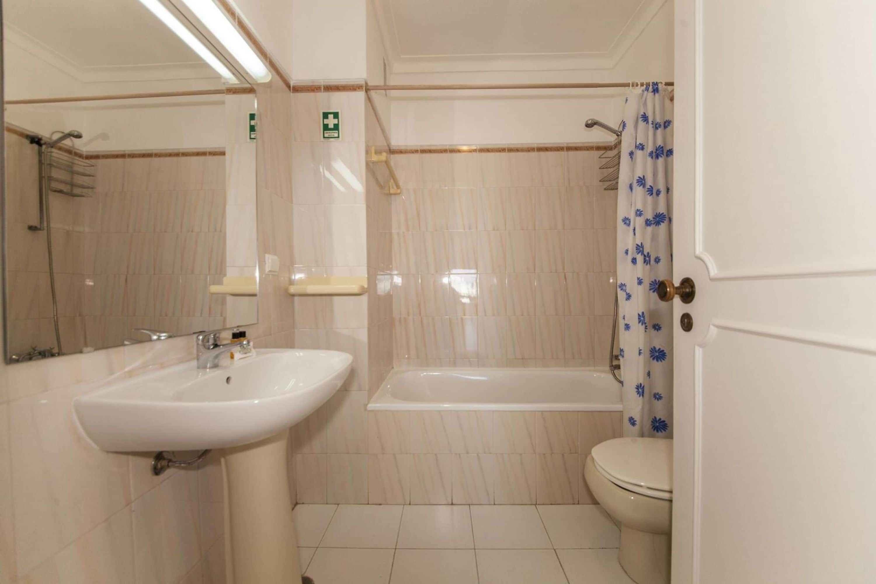 A bathroom with a sink, toilet, and bathtub.