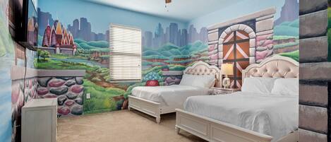 A bedroom with two beds, a ceiling fan, a window with blinds, and a mural on the walls.
