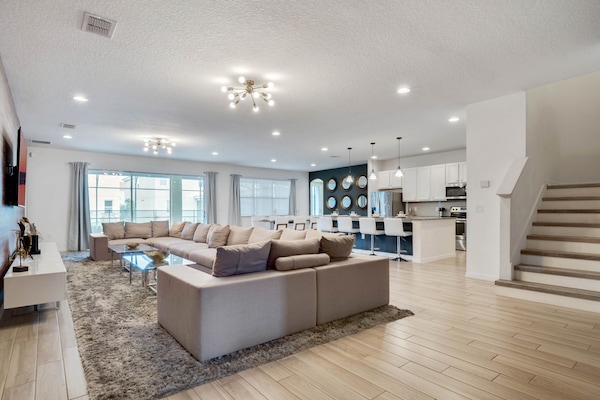- Spacious living room with sectional seating for the whole group  
- Open layout flows into modern kitchen and large dining table  
- Relax in comfort with streaming ready flat screen TV setup