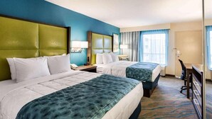 A hotel room with two beds, a desk, and a chair. - Quality Inn Gulfport I-10 (Gulfport)