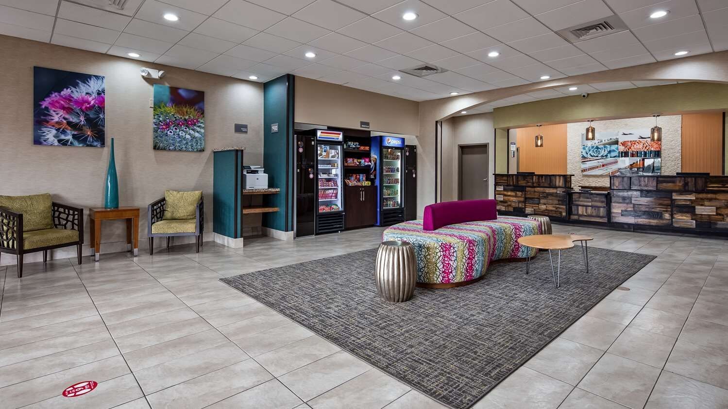 A lobby with seating, vending machines, and a reception area.