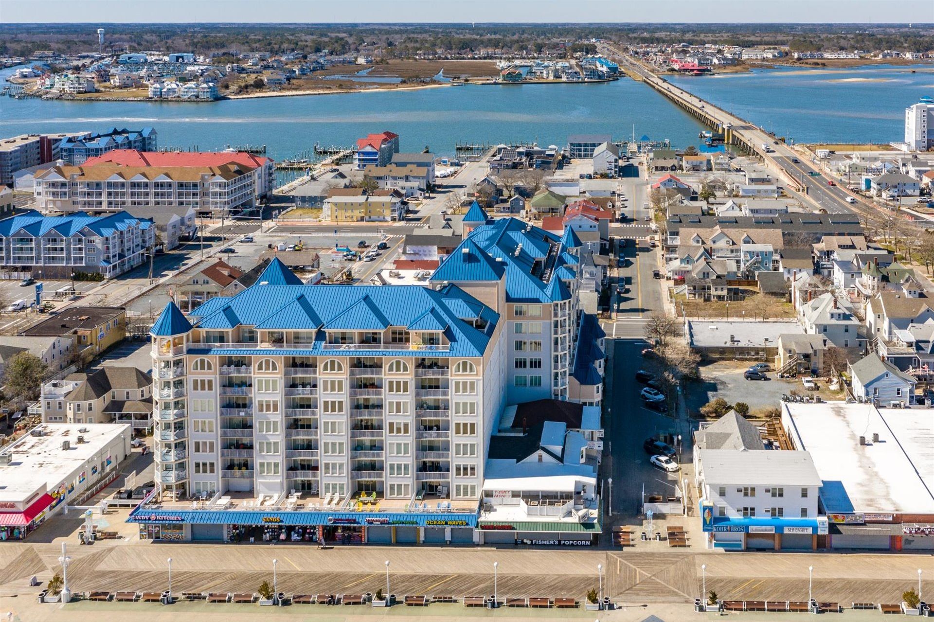 A coastal hotel with multiple floors, a beachside location, and a view of the sea.