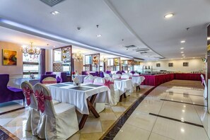 A banquet hall with tables set for a formal event, featuring a central aisle and a stage area. - T-Longee Hotel (Beijing)