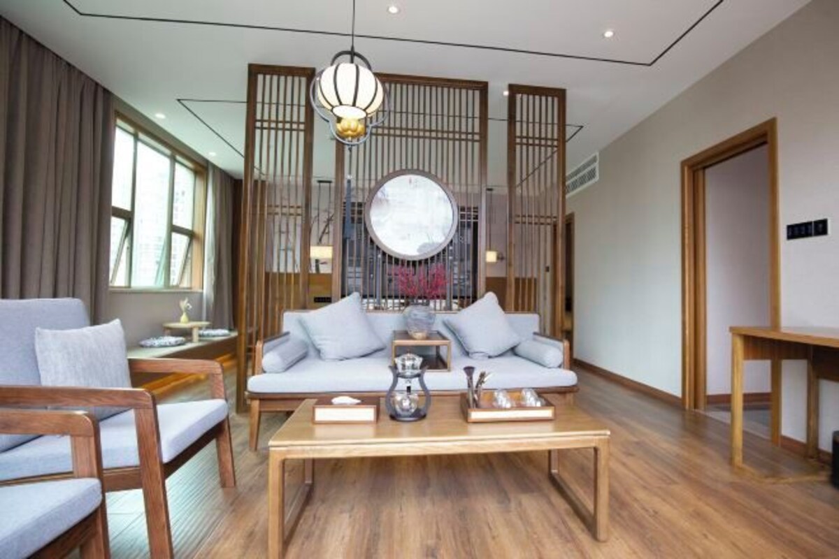 A modern living room with a sofa, coffee table, and decorative items.