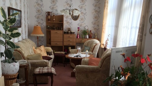 A cozy living room with a sofa, armchairs, a coffee table, and a fireplace. - Bunte Stadt an der Elde (Grabow)