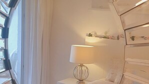 A sunburst mirror with a reflection of a room. - Relax your mind (Mijas)