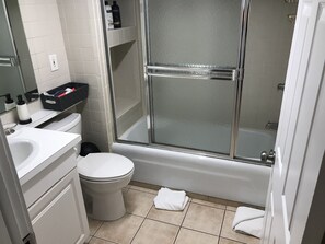 A bathroom with a toilet, sink, and shower area. - Quiet Studio, minutes from Beaches, Shopping, Dining, 5th Ave and 3rd Street (Naples)
