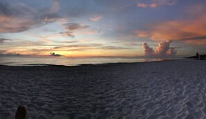 A beach with a sunset in the background and a sandy foreground. - Quiet Studio, minutes from Beaches, Shopping, Dining, 5th Ave and 3rd Street (Naples)