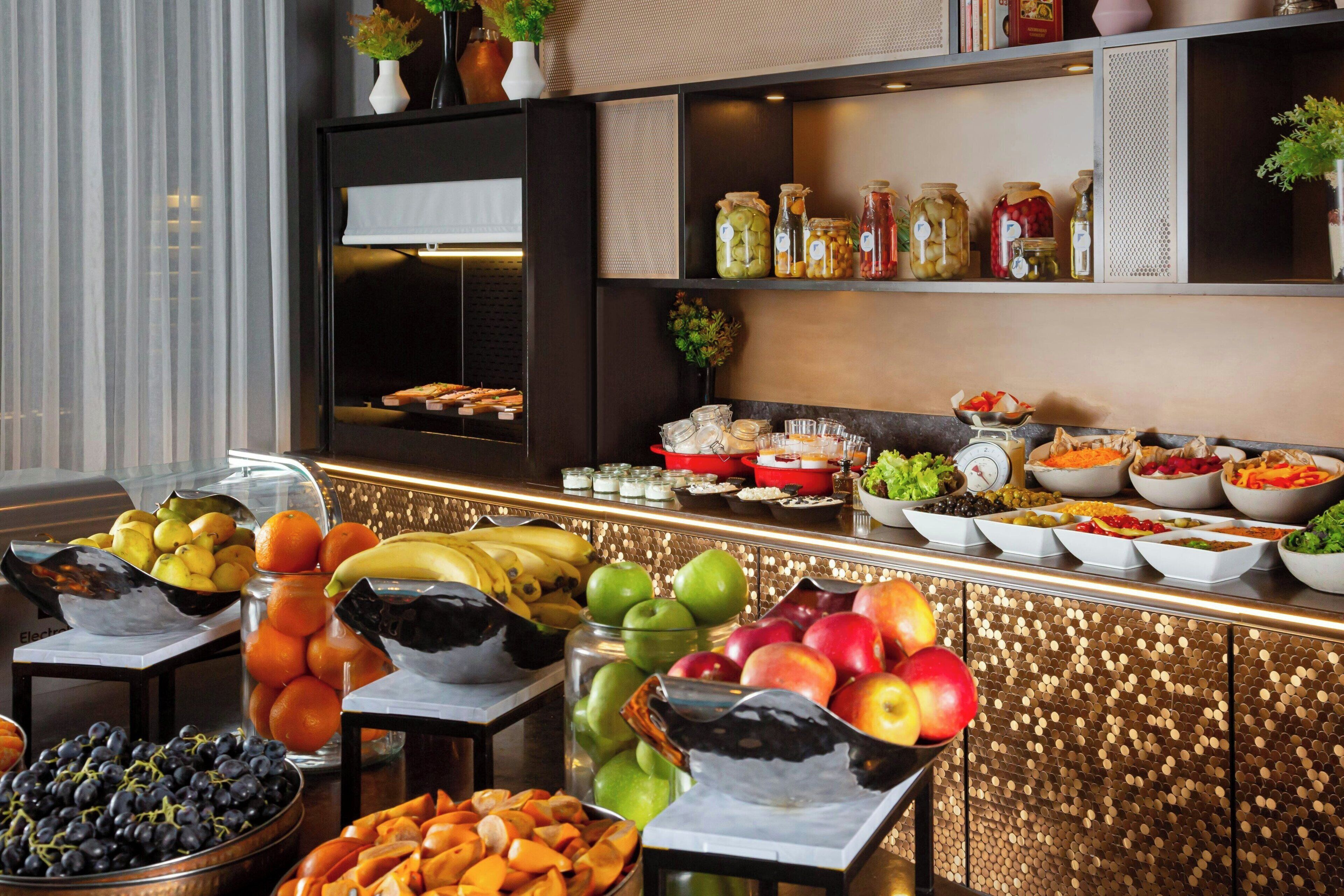 Een buffet met verschillende soorten fruit, groenten en sauzen.
