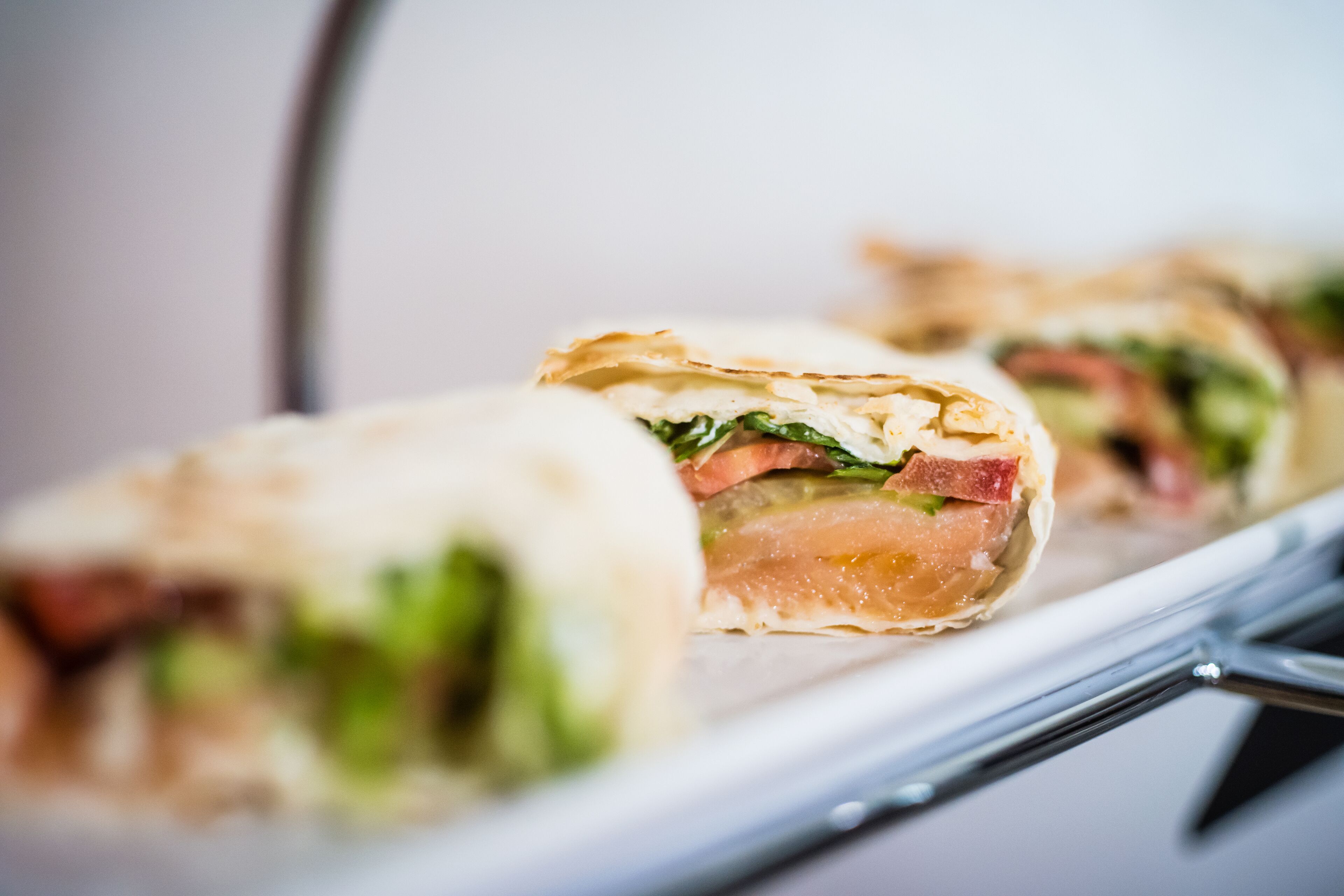 A tray of sandwiches with visible fillings like lettuce and tomato.