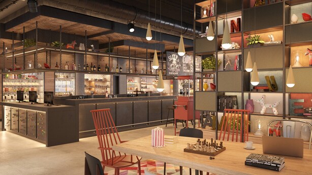 Un área de bar moderna con mostrador, asientos y varios objetos decorativos.