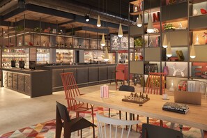 A modern bar area with a counter, seating, and various decorative items.