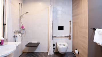 Un bagno moderno con doccia, WC e lavandino.