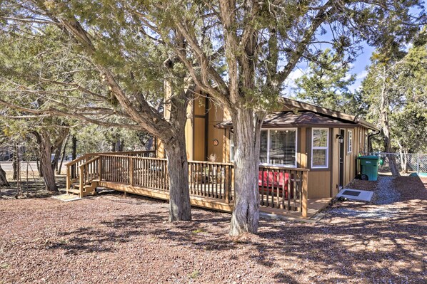 Surrounded by mature trees, this cozy cabin offers a peaceful retreat with a wooden deck and access.