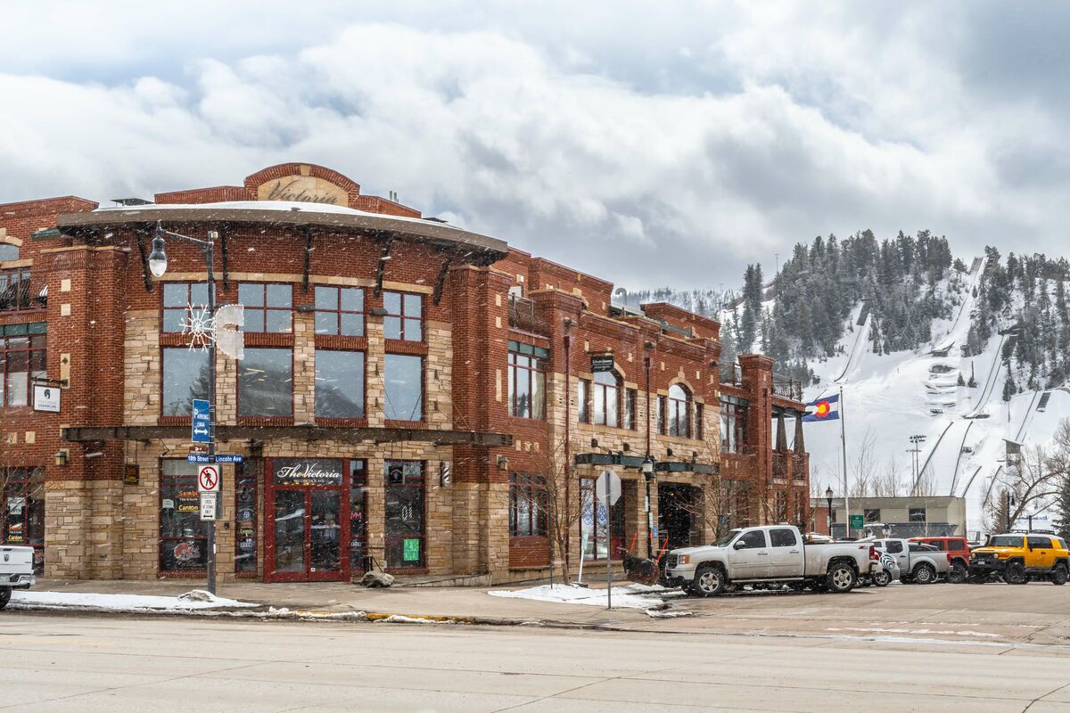 A brick building with a storefront named "Victoria."