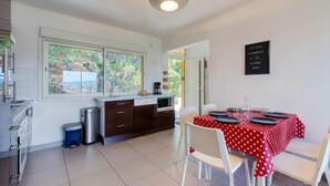 A compact kitchen with a dining area. - Les Coccinelles by Interhome (Cavalaire)