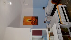 A room with two beds, a mirror, a dresser, and a poster on the wall.
