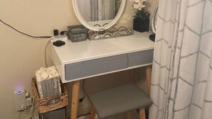 A bathroom vanity with a mirror, a small bench, and a potted orchid. - 🌴Luxe Oasis🌴Superhost🌴Post-Op🌴Solo & Couples Escape in Miami🌴 (Miami)
