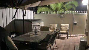 An outdoor patio with a table and chairs, a grill, and a white picket fence. - 🌴Luxe Oasis🌴Superhost🌴Post-Op🌴Solo & Couples Escape in Miami🌴 (Miami)