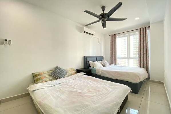 A hotel room with two beds, a ceiling fan, an air conditioning unit, and a window with curtains. - OYO 90192 Mansion One Suites (George Town)