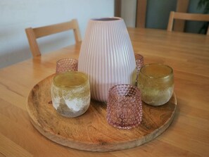 A wooden table with a glass candle holder and three candles. - Peaceful Stay in Winterberg (Winterberg)