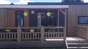 Enjoy a peaceful retreat with a covered porch, perfect for relaxing and taking in the surroundings.