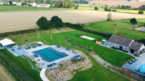 An aerial view of a property with a large swimming pool, a covered patio area, and a barn. - Nice Cottage in a Castle-farm in Ohey With Swimming Pond (Ohey)