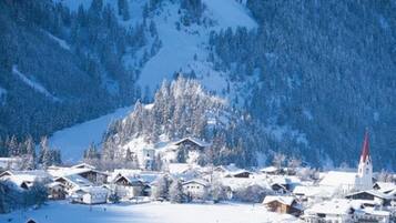 A snow-covered village with houses and a church.