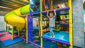 A child playing on a colorful indoor play structure with multiple levels and slides. - Modern Chalet With Combi Microwave Near Efteling (Kaatsheuvel)