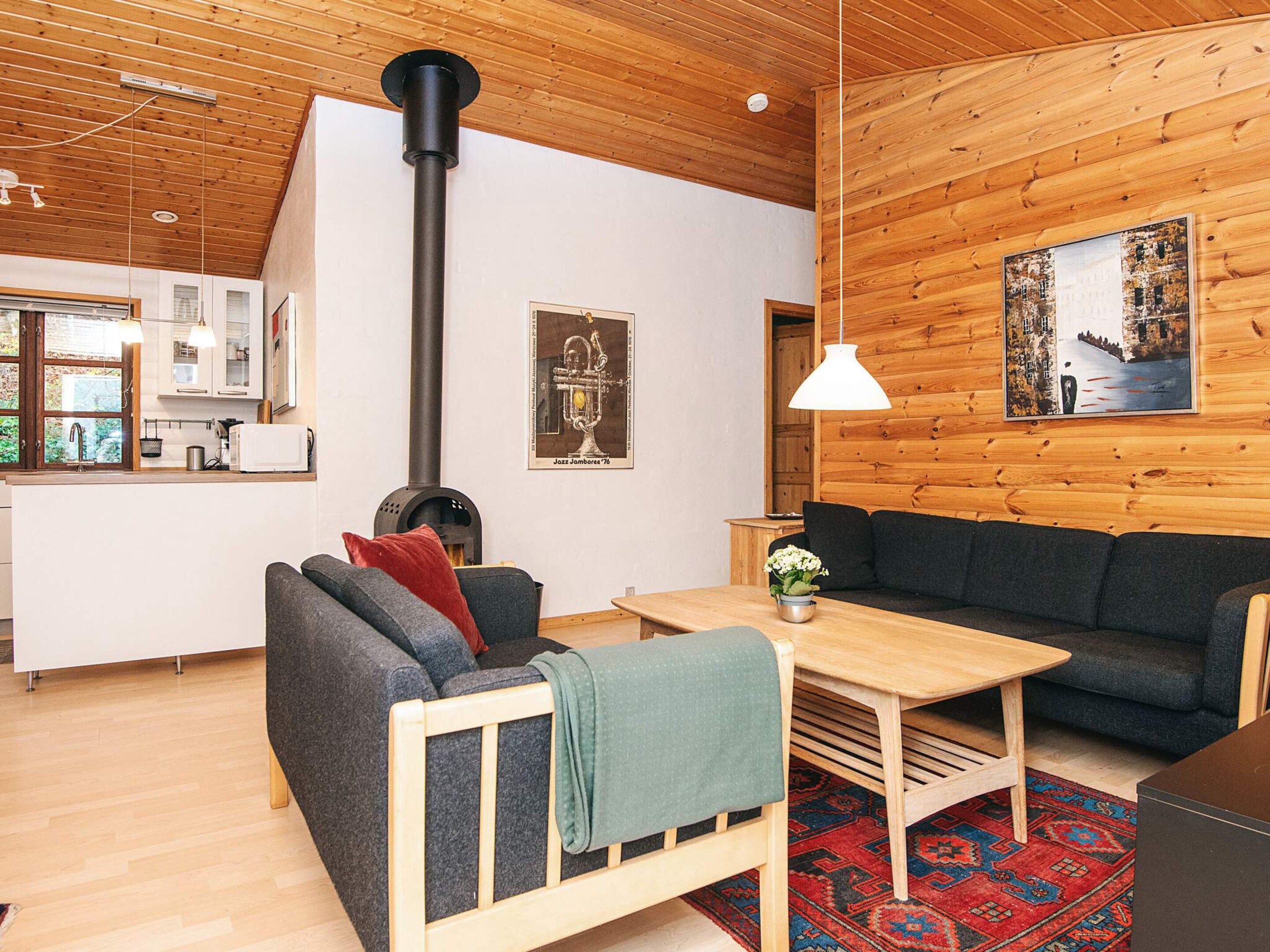 A cozy living room with a sofa, a coffee table, and a fireplace.
