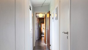 A narrow hallway with tiled flooring, white walls, and doors leading to rooms. - 6 Person Holiday Home in Gorlev (Gørlev)