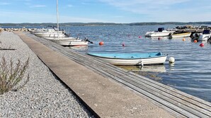 A dock with several boats moored alongside. - 7 Person Holiday Home in Hakenaset (Hakenäset)